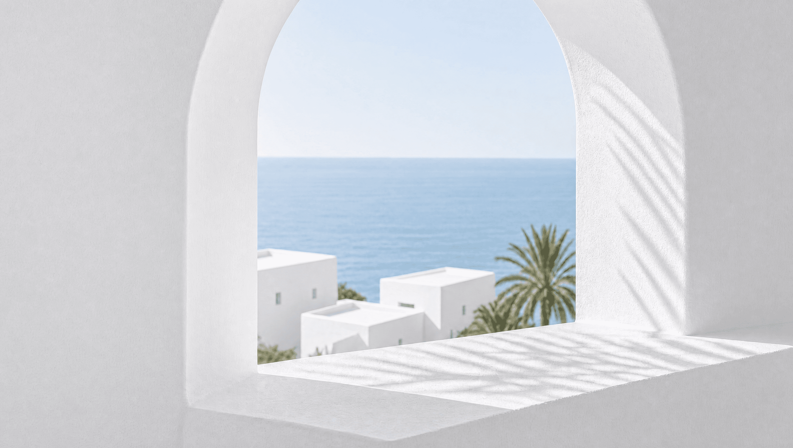 Arched window with a view of the sea, white houses and a palm tree