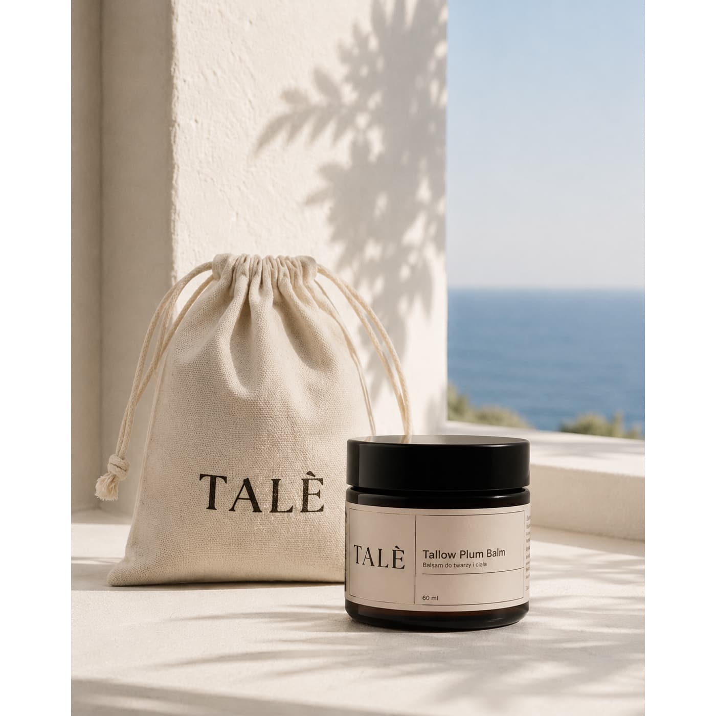 Lniany woreczek TALÈ i słoik balsamu Tallow Plum Balm na tarasie z widokiem na morze